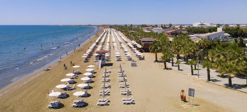  A lively beachfront area known for its soft sand, clear water, and vibrant atmosphere, viewed beautifully from the sea.