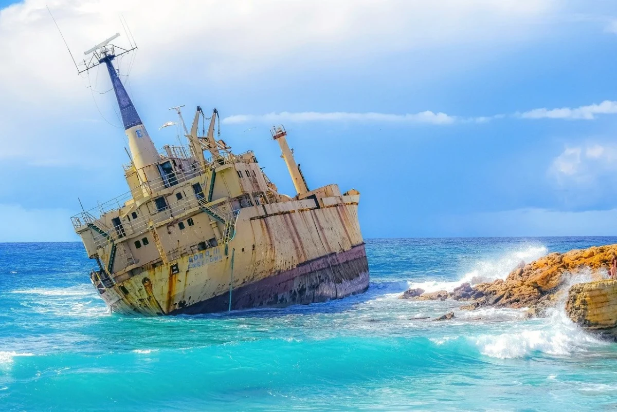  A striking abandoned ship resting near the shore, creating a dramatic and unique sightseeing location.